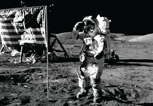 astronaut saluting the American flag on the moon