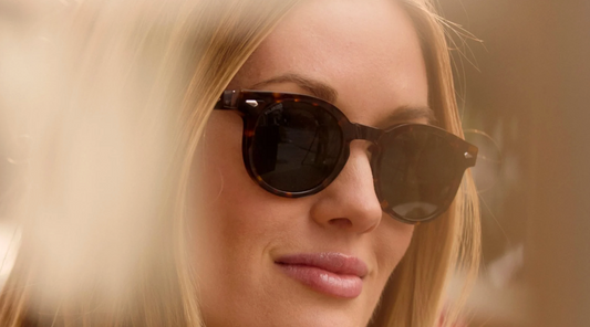 close up of a blonde woman in tortoise shell sunglasses